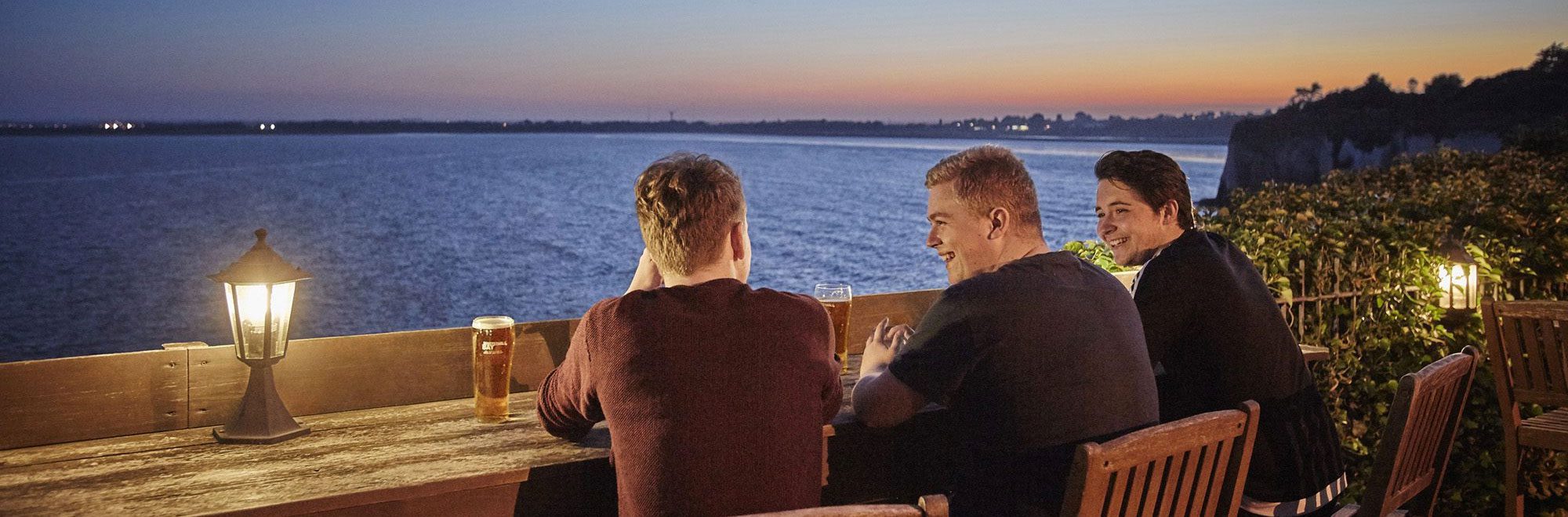 Couple looking at map outside pub